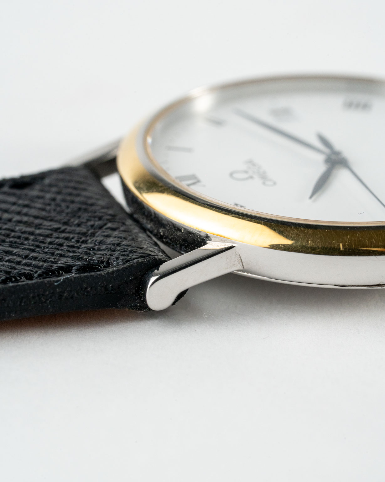 Vintage Omega De Ville quartz with white roman numeral dial in a two-tone case reference 198.2378 from the 1990s watch bezel