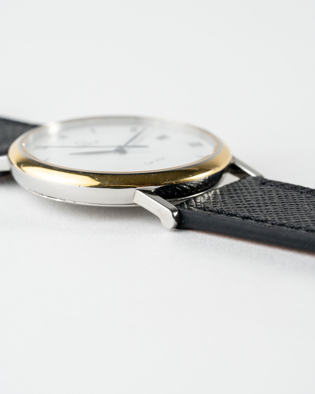 Vintage Omega De Ville quartz with white roman numeral dial in a two-tone case reference 198.2378 from the 1990s watch lug