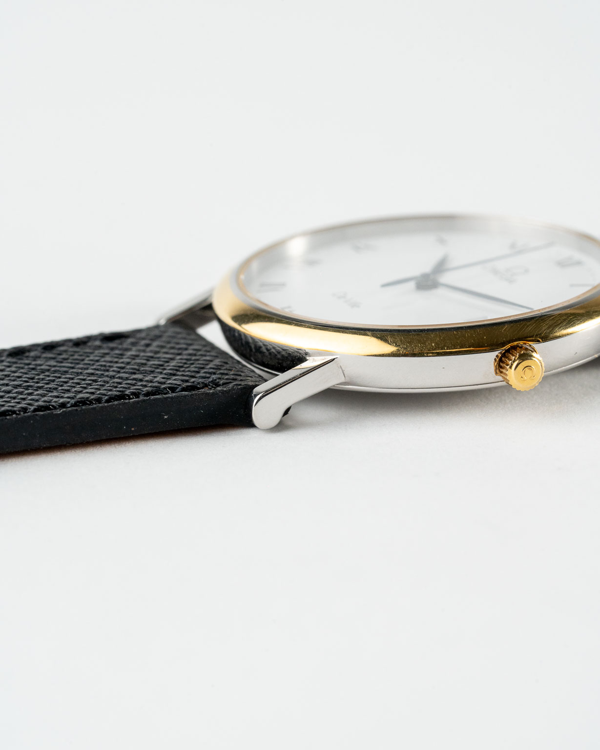 Vintage Omega De Ville quartz with white roman numeral dial in a two-tone case reference 198.2378 from the 1990s watch lug and crown