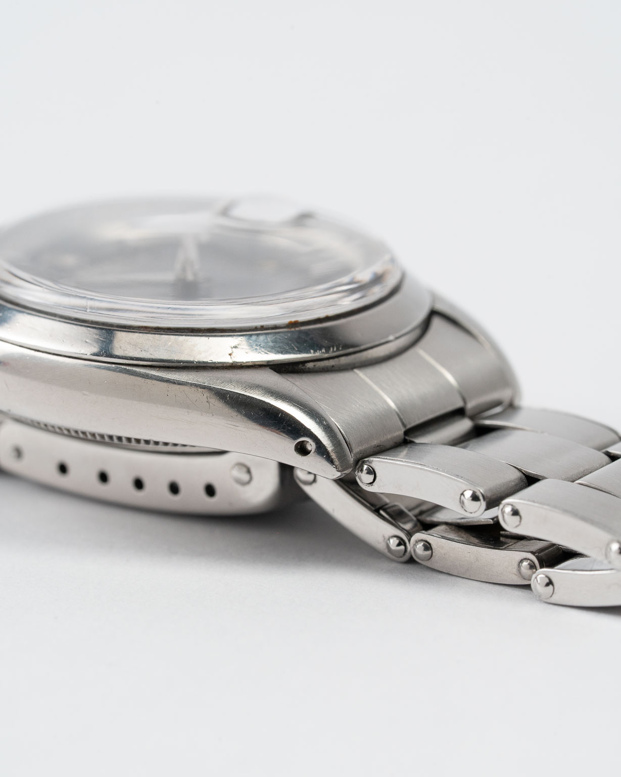 Vintage Rolex Oyster Perpetual Date 1500 stainless steel Black Gilt (tropical) dial on riveted oyster from 1964 lug 2