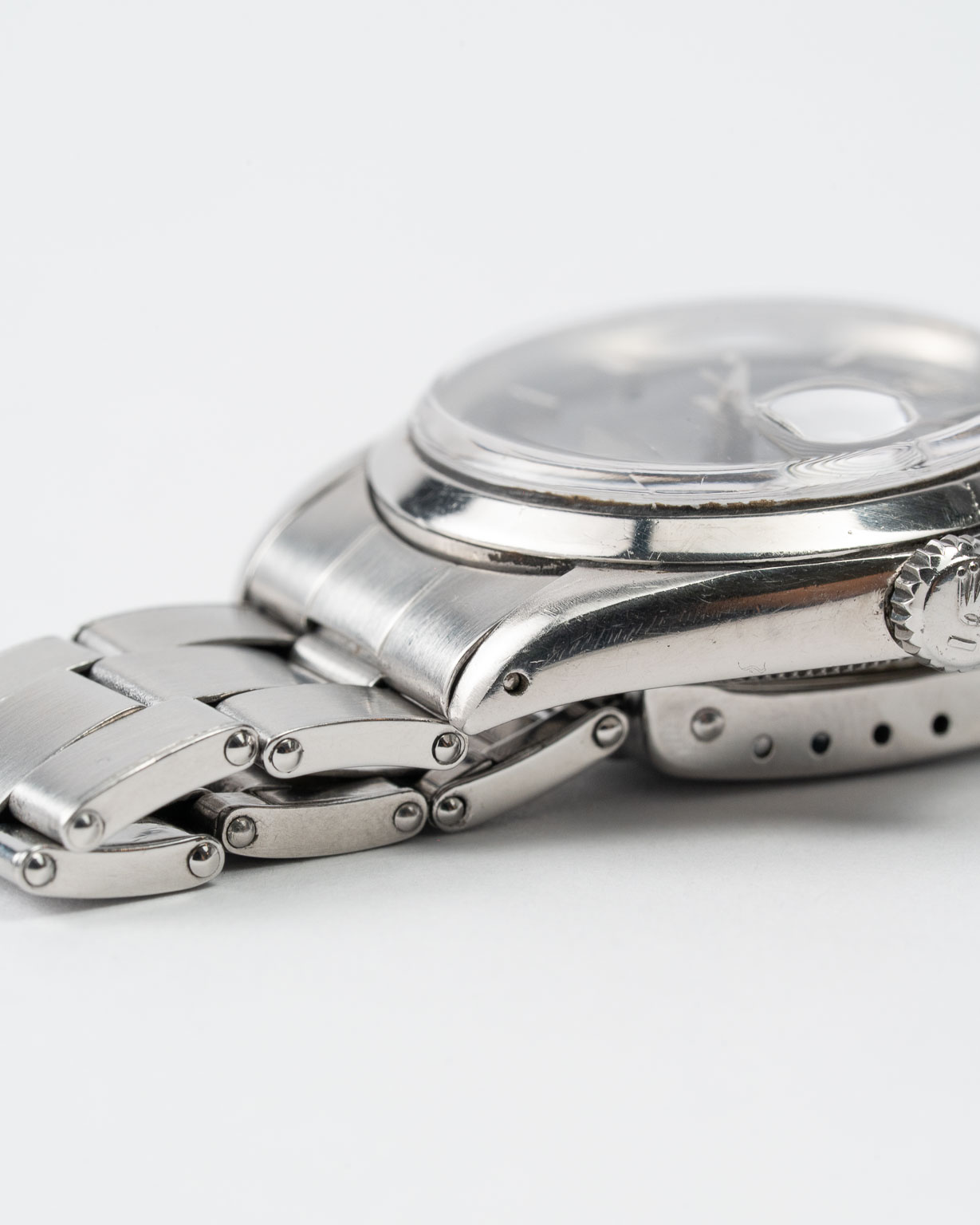 Vintage Rolex Oyster Perpetual Date 1500 stainless steel Black Gilt (tropical) dial on riveted oyster from 1964 lug 4