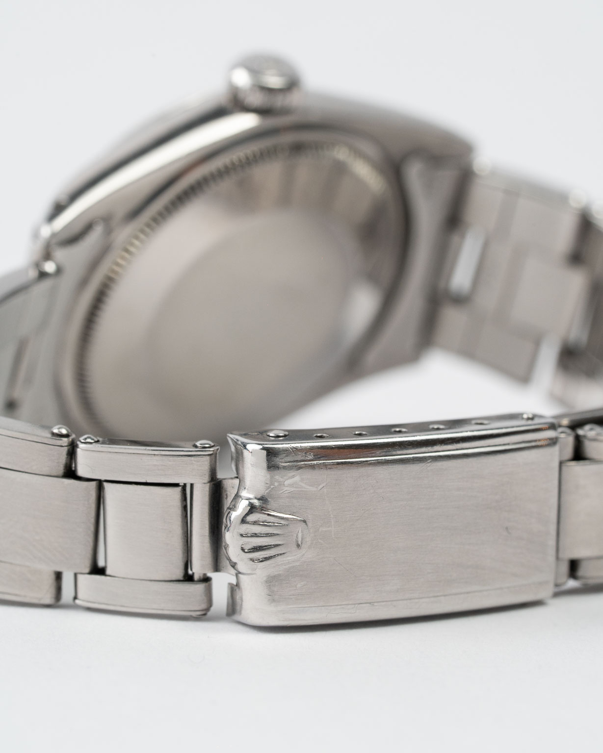 Vintage Rolex Oyster Perpetual Date 1500 stainless steel Black Gilt (tropical) dial on riveted oyster from 1964 clasp